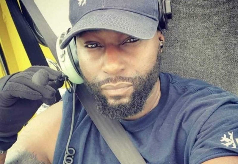 Dominick Wright posing with his motorcycle, wearing a leather jacket